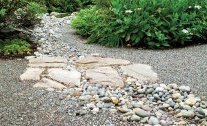 Natural stone pathways help break up slopes and hills in your landscape.