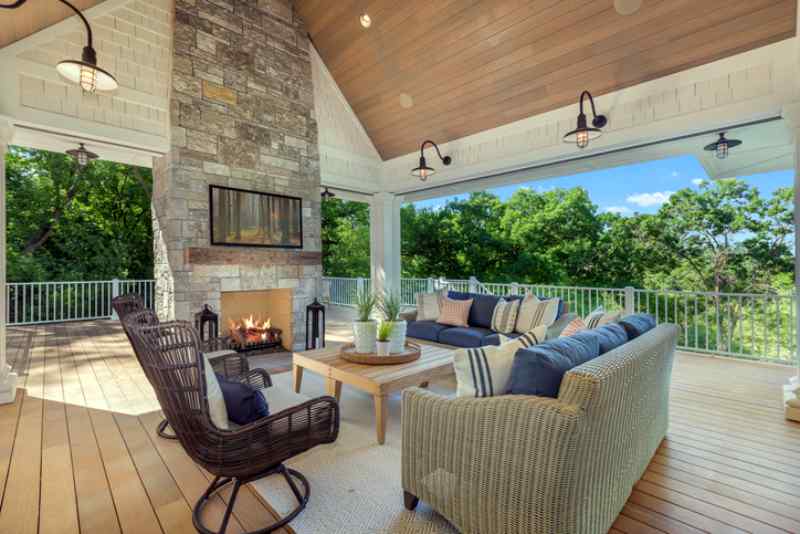 Lakeside luxury home with huge deck with beautiful vaulted covering and stone outdoor fireplace.