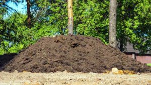 Big pile of dirt to be hauled at a landscape construction site