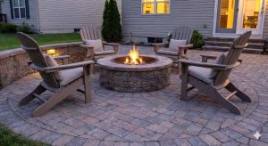 An outdoor living space with fire pit and stone patio.