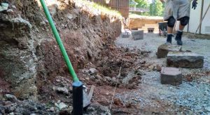 Heartland landscaper working on a retaining wall.
